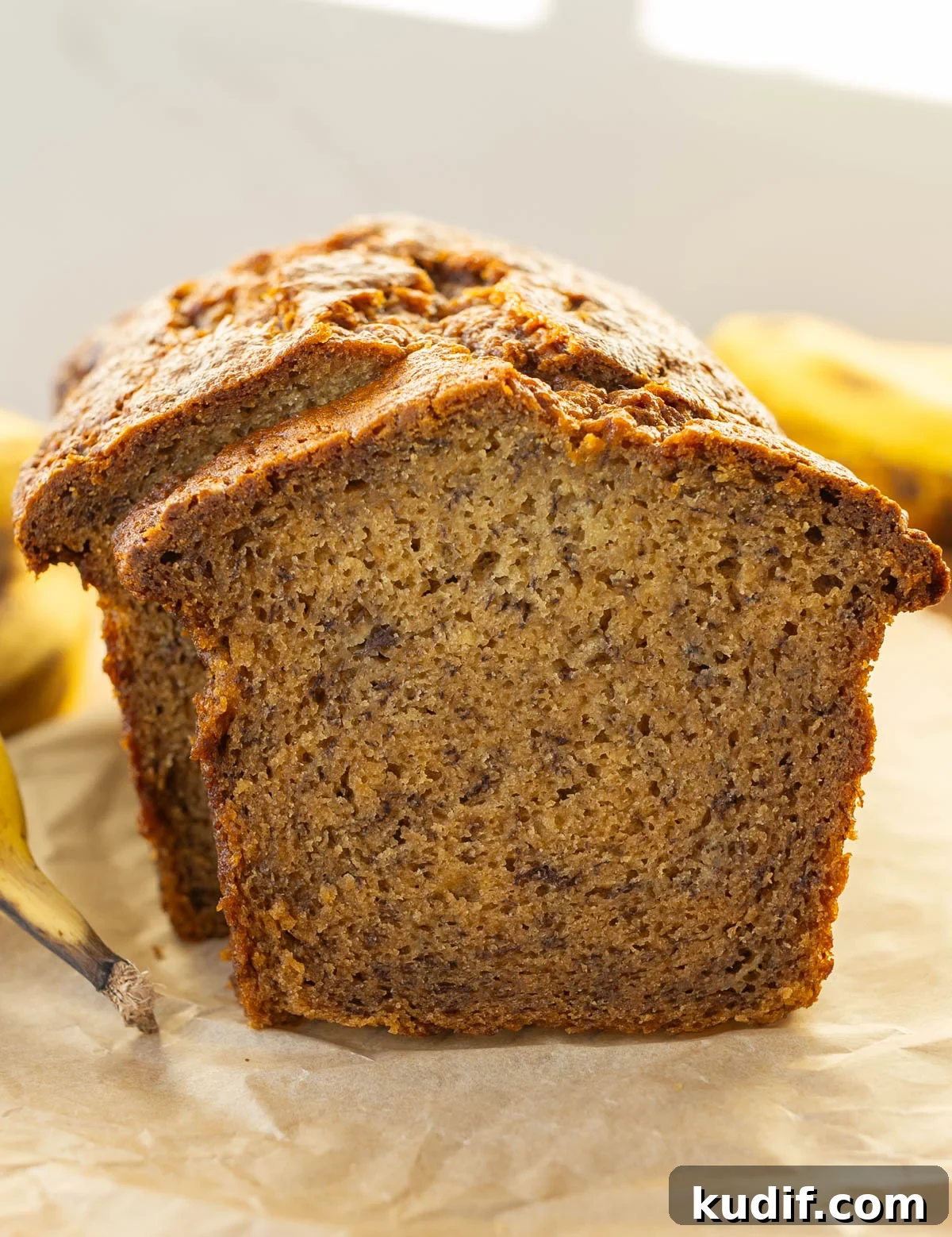 This dense, sweet, cake-like banana bread recipe is super moist! It's less sweet than a cake using ripe bananas and is one of the quickest breads to make for breakfast or tea! super moist banana bread with ripe bananas