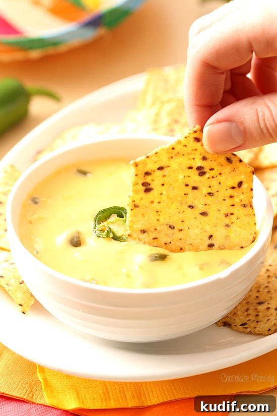 Homemade Queso: Creamy Nacho Cheese Dip Recipe 5 Dipping into Nacho Cheese Dip