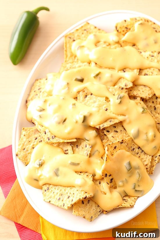 Homemade Queso: Creamy Nacho Cheese Dip Recipe 7 Queso poured over nachos