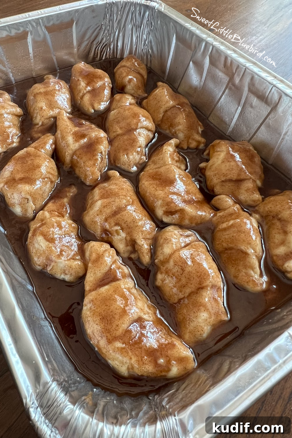 Crescent Roll Peach Dumplings with Warm Cinnamon Sauce 6 Dumplings in the pan with the cinnamon-sugar-butter mixture spooned over them.