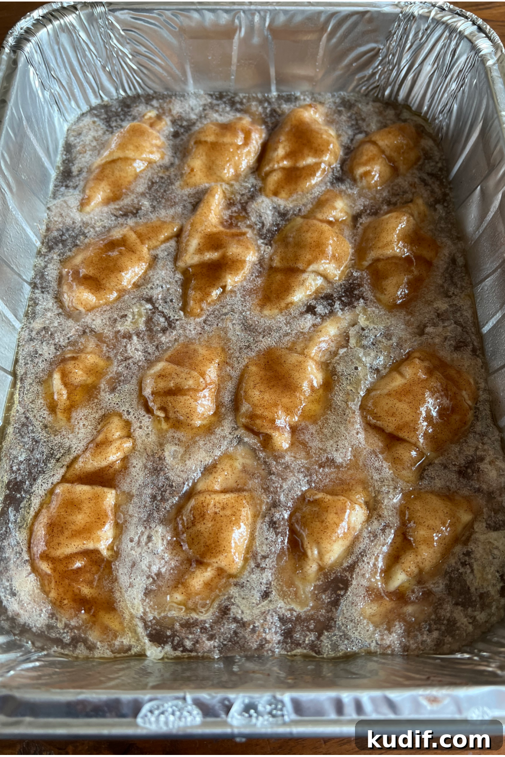 Crescent Roll Peach Dumplings with Warm Cinnamon Sauce 8 Dumplings in the baking pan after adding Sprite.