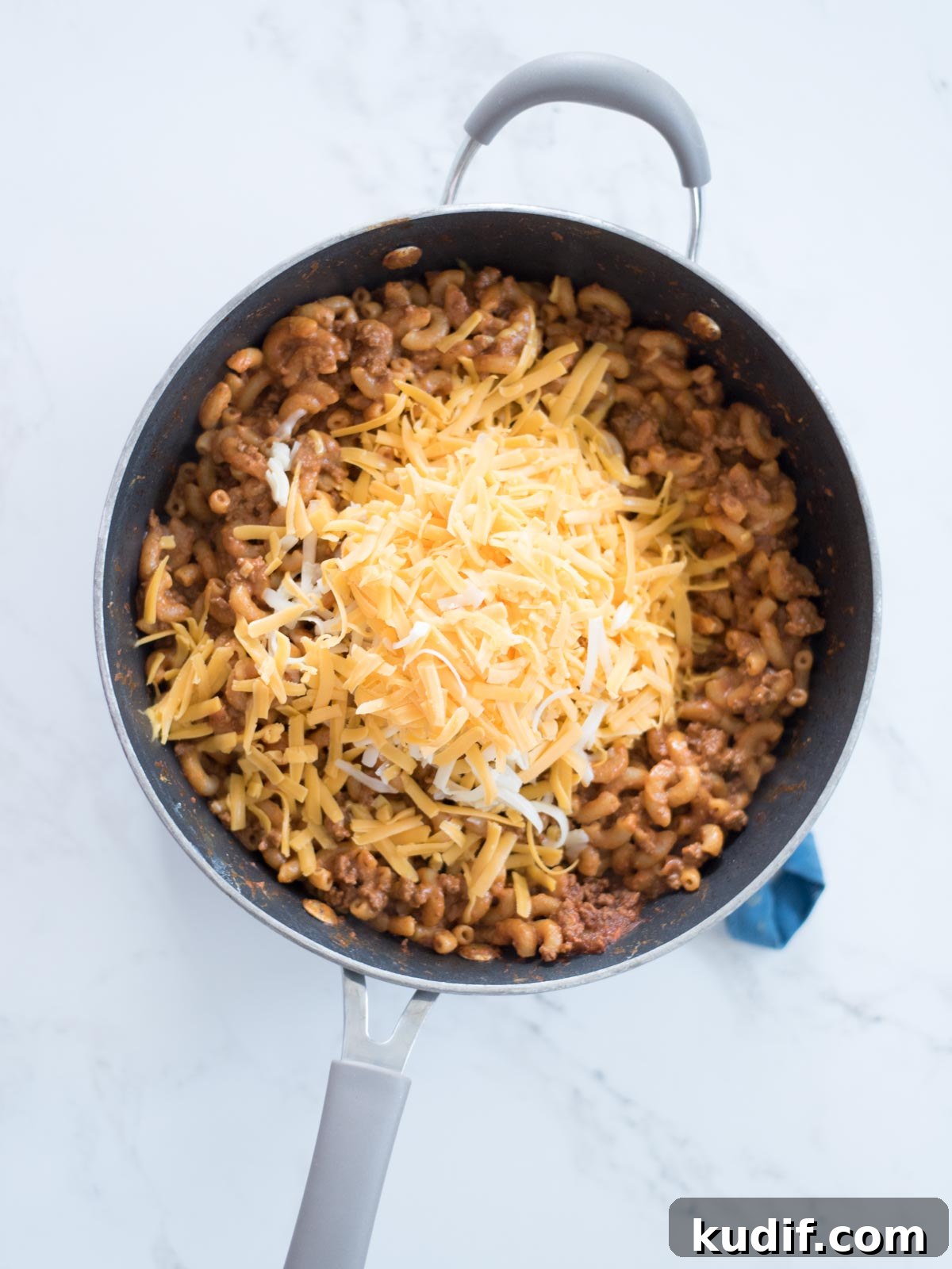 Cheesy Taco & Cream Cheese Pasta Recipe for Weeknight Dinners 8 one pot cheesy taco pasta in a skillet topped with cheese
