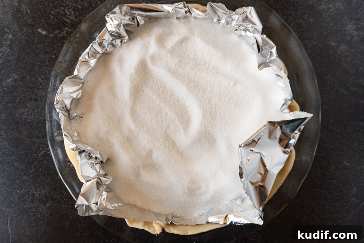 sugar weighing down foil in pie dish