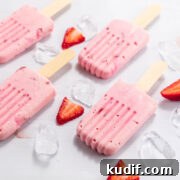 Low carb creamy strawberry creamsicles with sliced berries and ice.