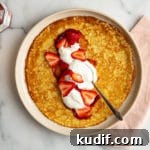 Gluten free crepe filled with strawberry jam, whipped cream and sliced strawberries.