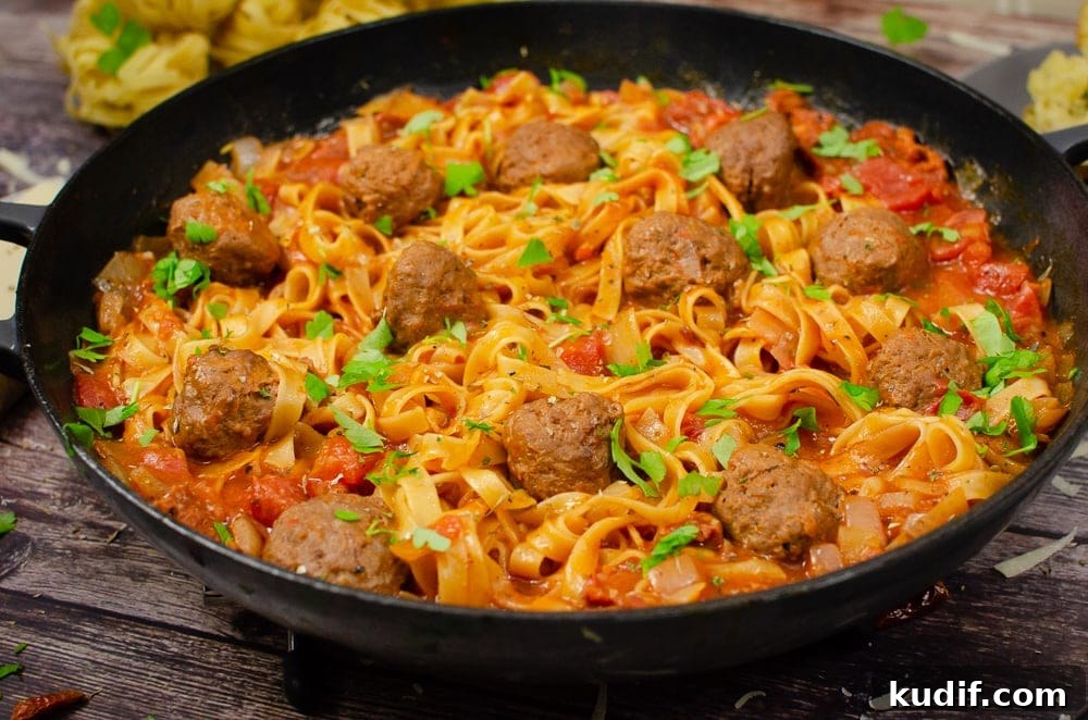 Spicy One-Pot Meatball Pasta Recipe for Quick Dinners 5 One-Pot Spicy Meatball Pasta served in a cast iron pan with sprinkled chopped parsley on top for garnish