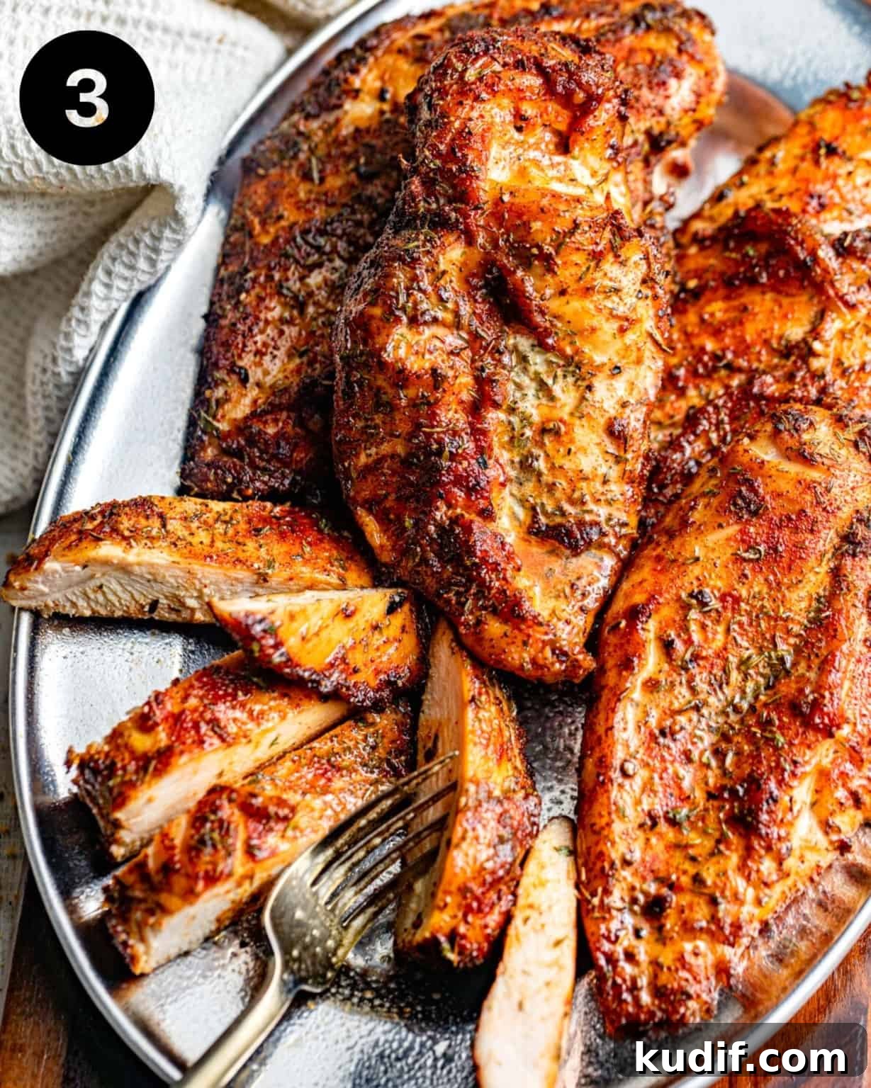 sliced smoked chicken breasts on a serving plate.