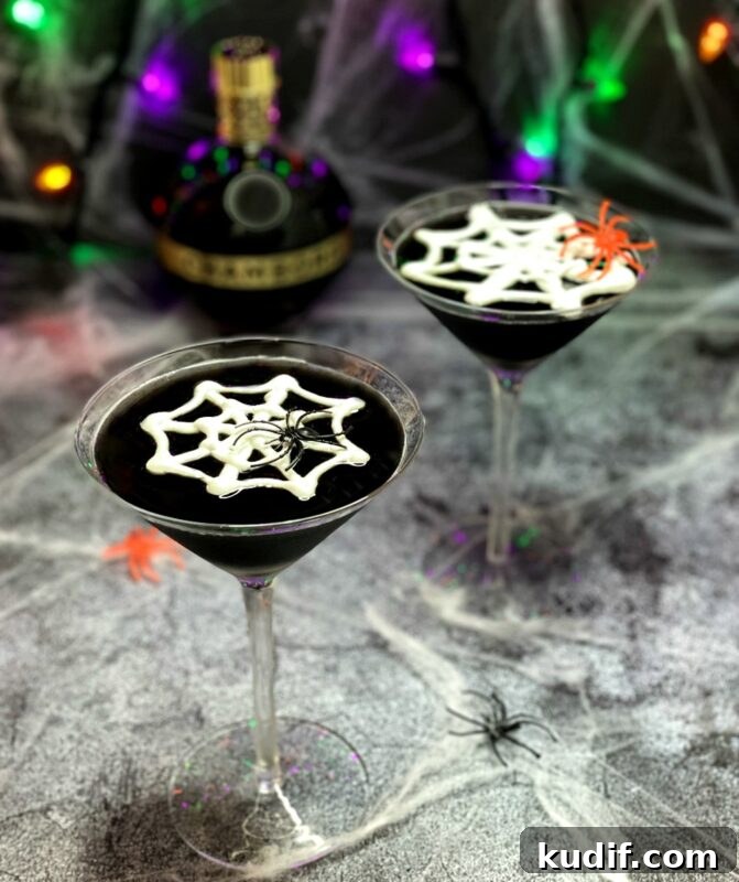 Black Martini Cocktail Recipe and Serving Guide 2 black halloween martinis with meringue webs on top.