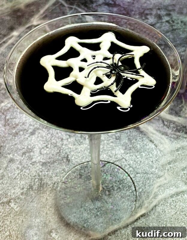 Black Martini Cocktail Recipe and Serving Guide 3 a black vodka martini with a meringue web and a toy spider on top.