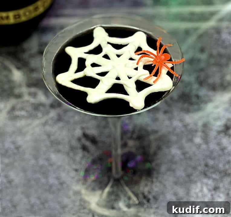 Black Martini Cocktail Recipe and Serving Guide 7 black martini with a meringue spider web and an orange spider garnish.
