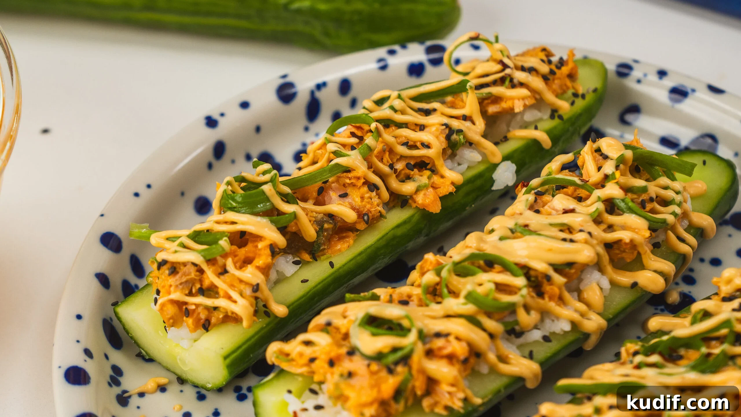 Spicy Salmon Cucumber Boats Made from Leftover Ingredients 8 Spicy salmon cucumber boats sitting on a platter.