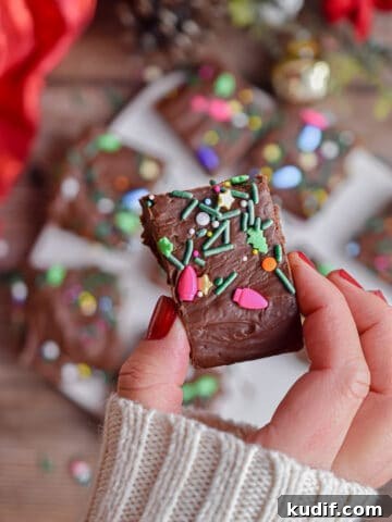 A hand is holding a piece of fudge.