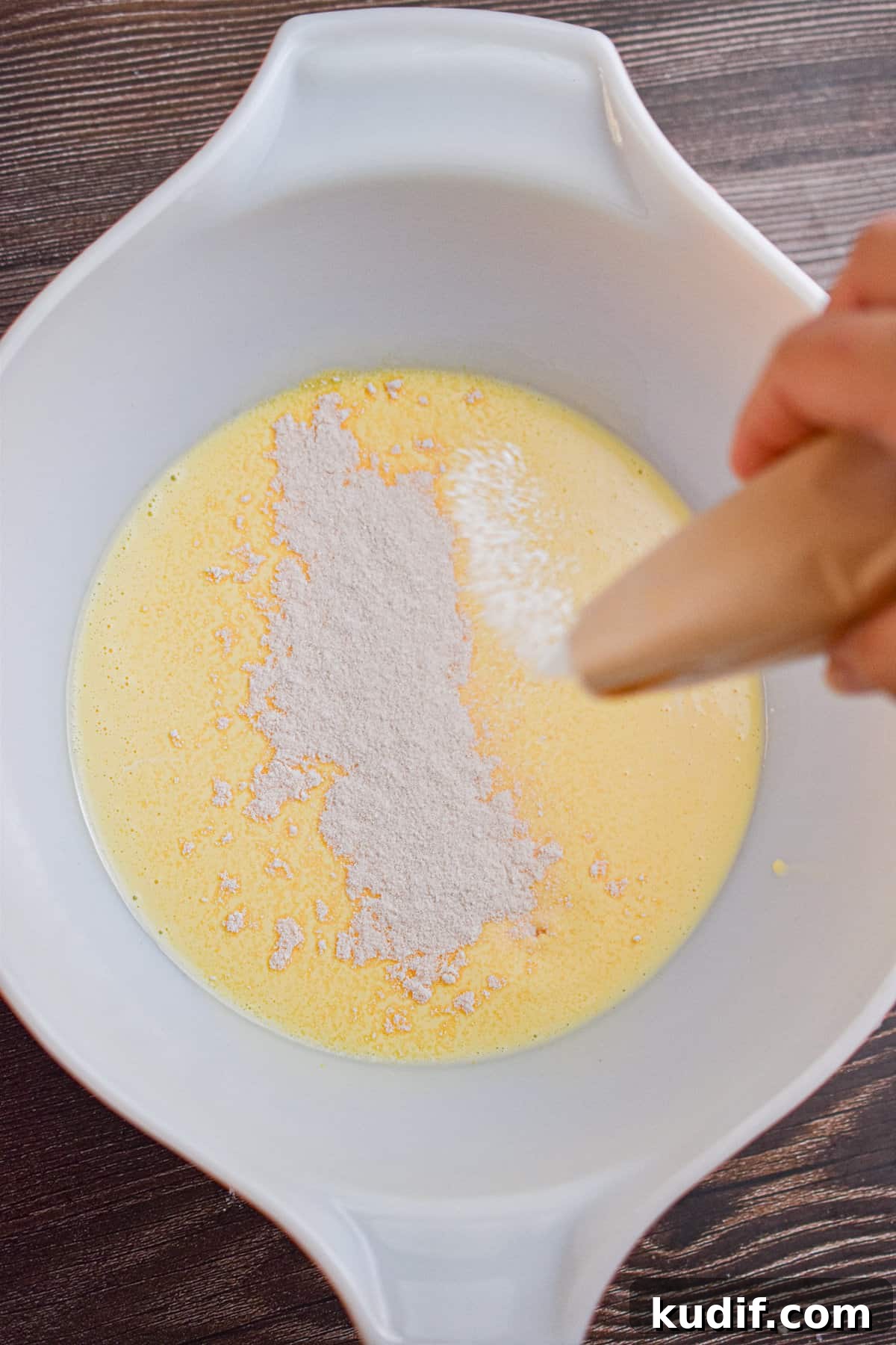 A package of vanilla pudding is sprinkled over the eggnog.