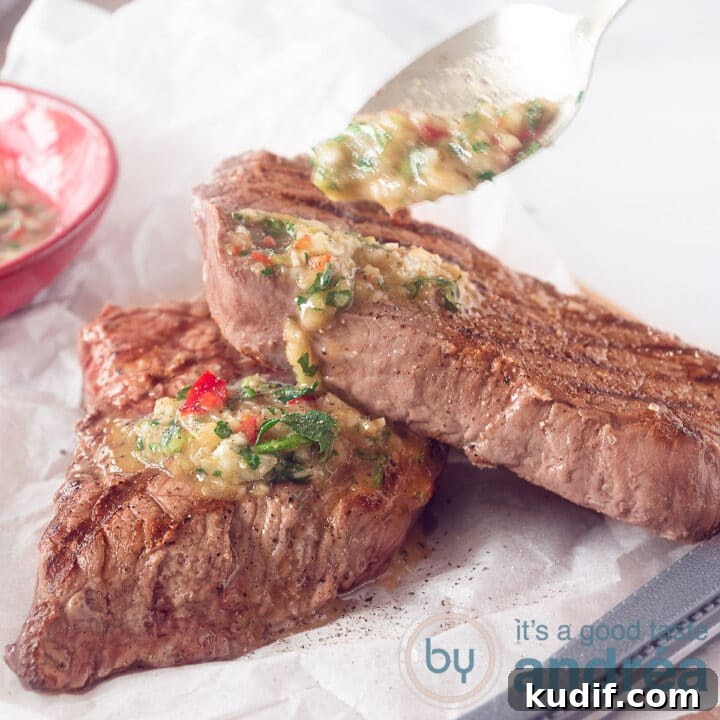 a square photo with white bakign paper where two grilled steaks are on top. a spoon adds some chimichurri sauce