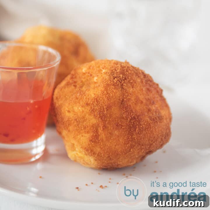 a square photo with papas rellenas and a glass filled with chili sauce