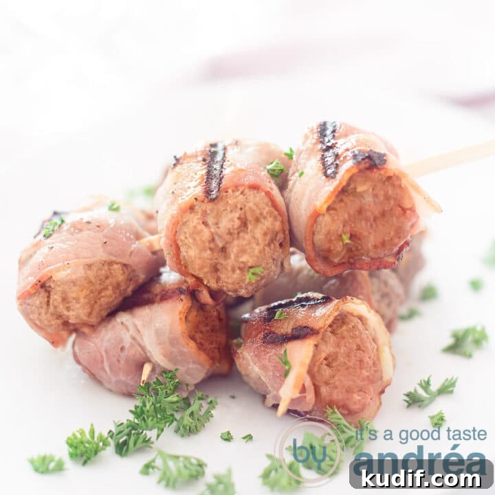 A square photo with two minced meat skewers crosswise (wrapped in bacon) sprinkled with parsley