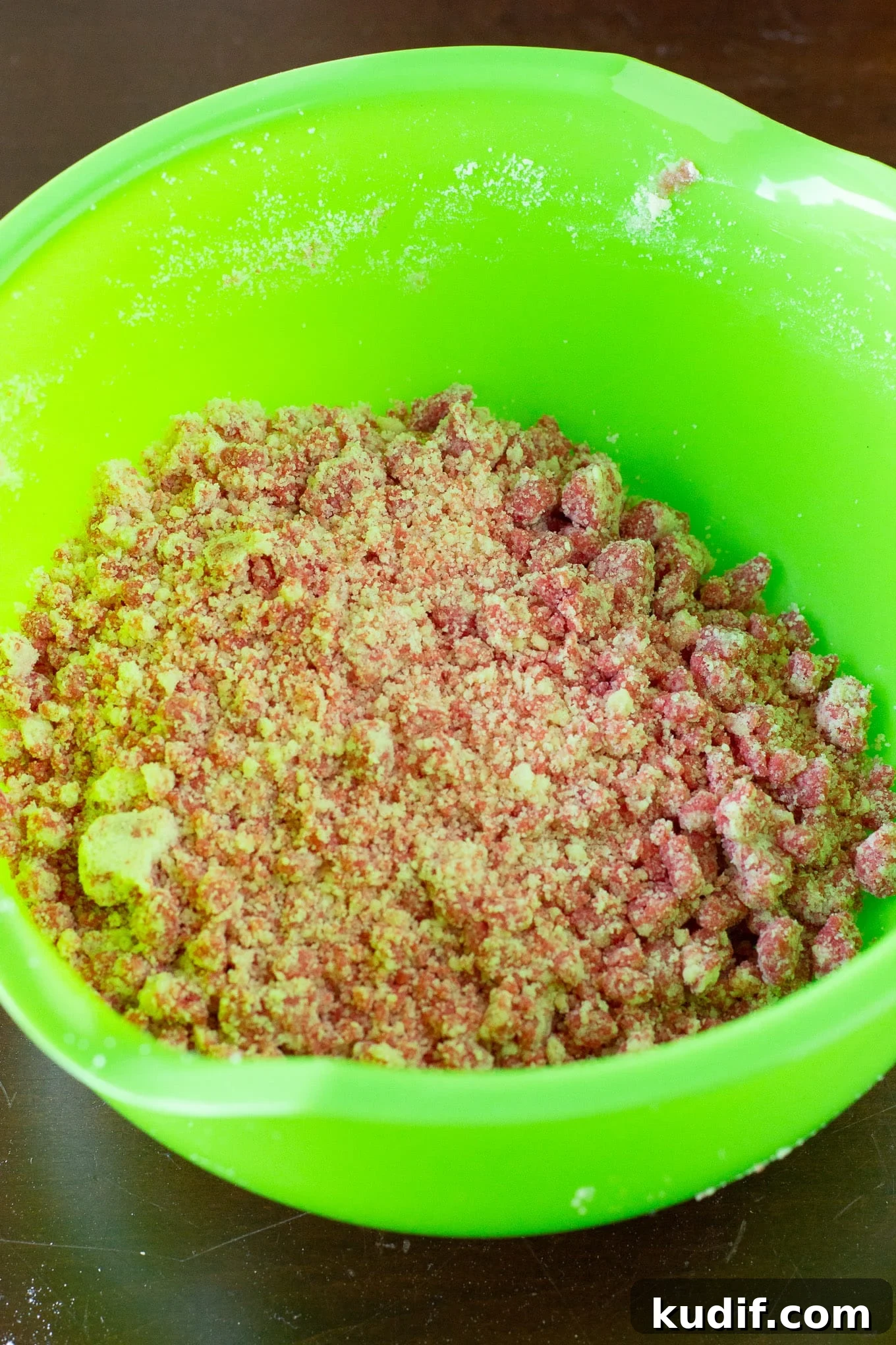 Crumble being mixed in a mixing bowl. 