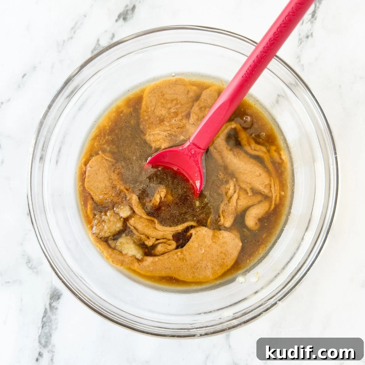 Asian Almond Butter Dipping Sauce (No-Cook) 4 Almond butter and ingredients for Asian dipping sauce in a glass bowl before blending with a red spatula.