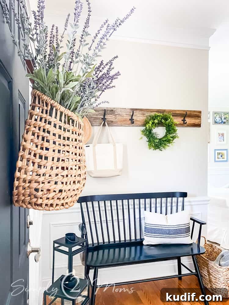 front door basket hanging on door in foyer with bench and row of hooks shown behind basket
