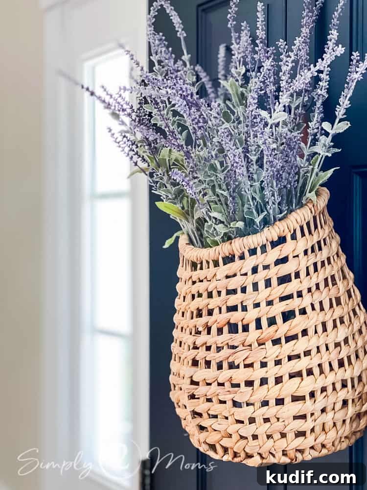close up of wicker door basket hanging on front door filled with faux lavendar