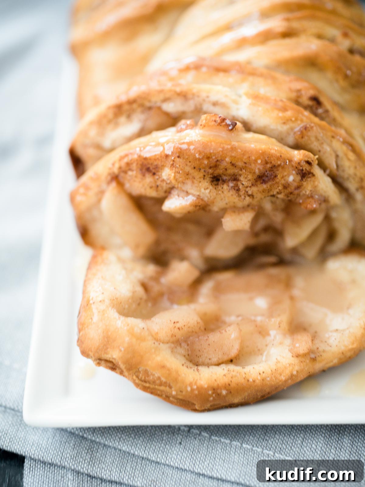 Pull‑Apart Apple Cinnamon Bread Made with Biscuits 3 bread on a white plate