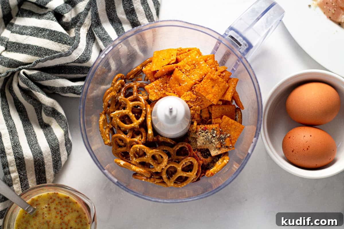 Food processor filled with pretzels and cheez its 