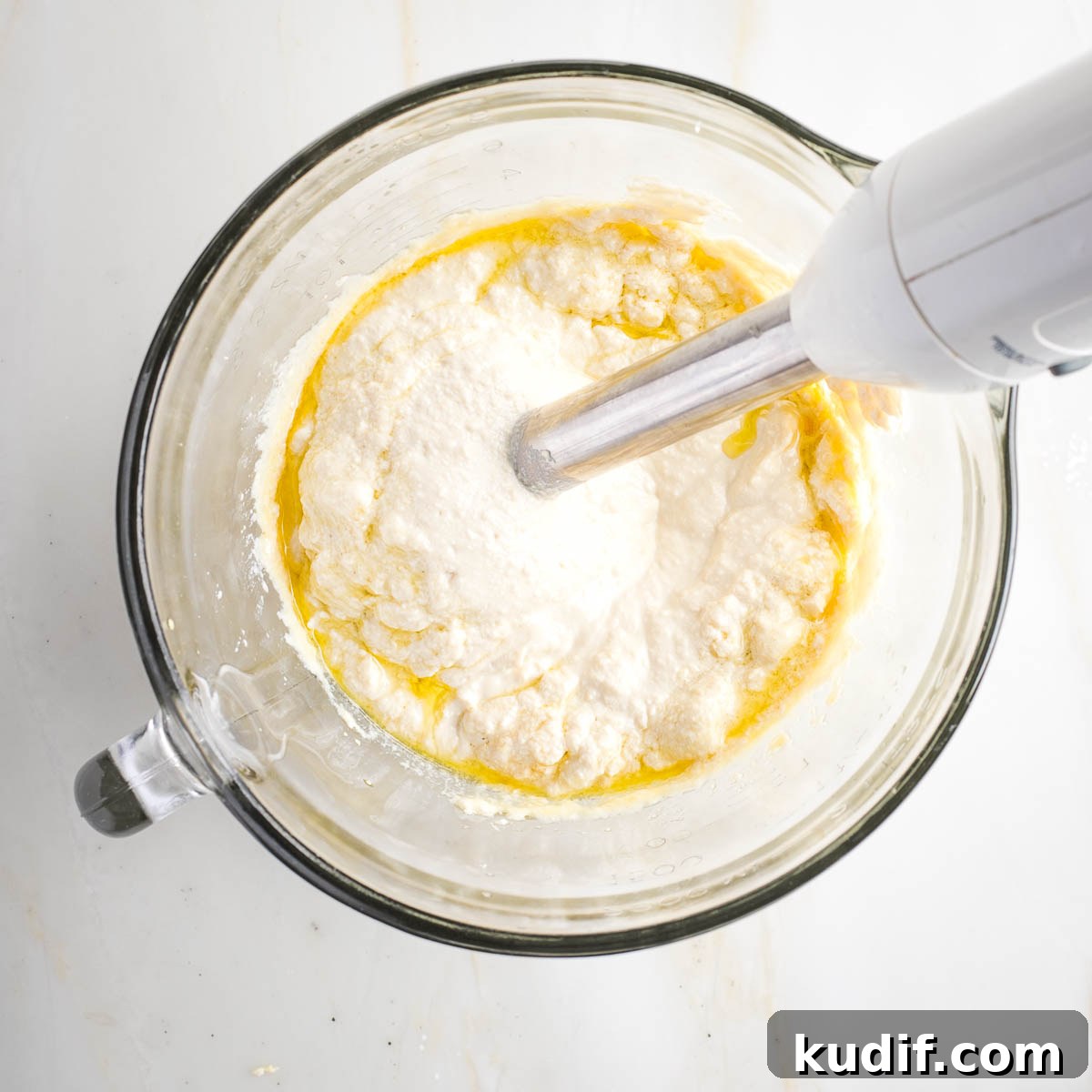 Creamy Tofu Vegan Mayonnaise Recipe — Quick & Luscious 8 Immersion blender making mayonnaise in a glass measuring cup.