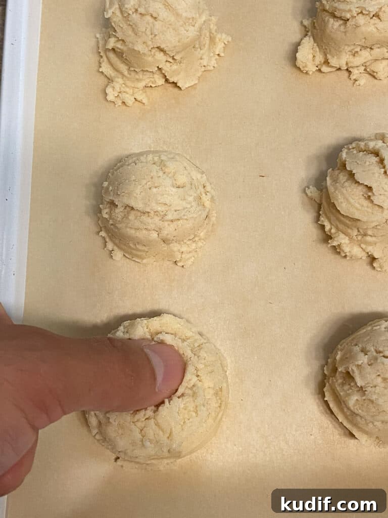 Raspberry Jam Thumbprint Cookies Recipe for Soft, Buttery Cookies 13 process shot of creating divot in dough