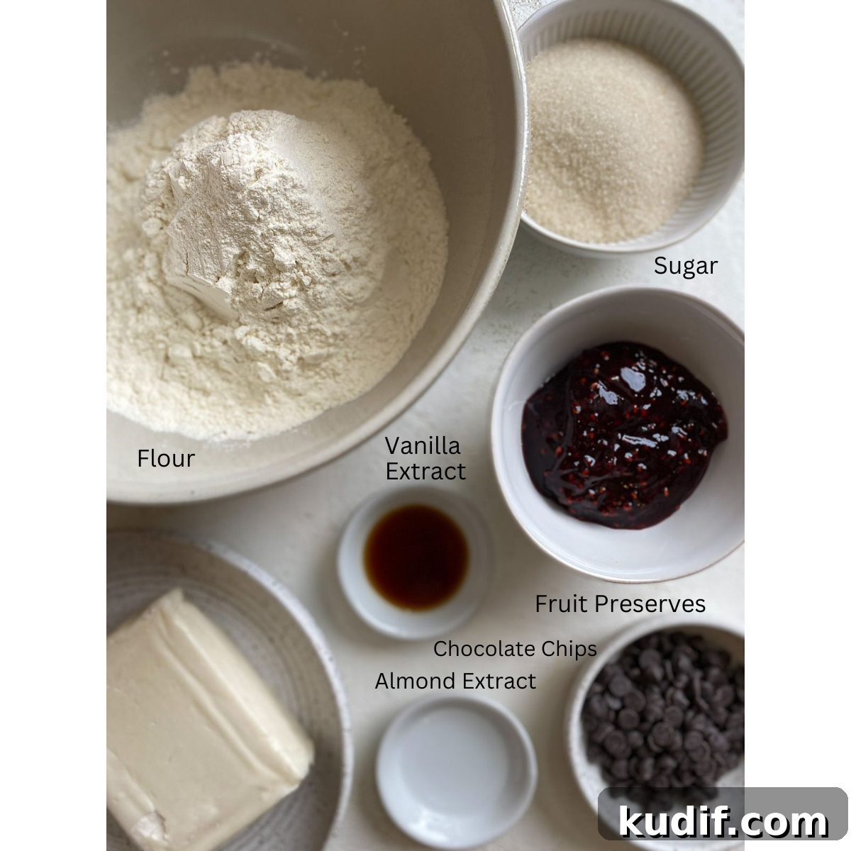 Raspberry Jam Thumbprint Cookies Recipe for Soft, Buttery Cookies 3 ingredients for Raspberry Thumbprint Cookies measured out against a white surface