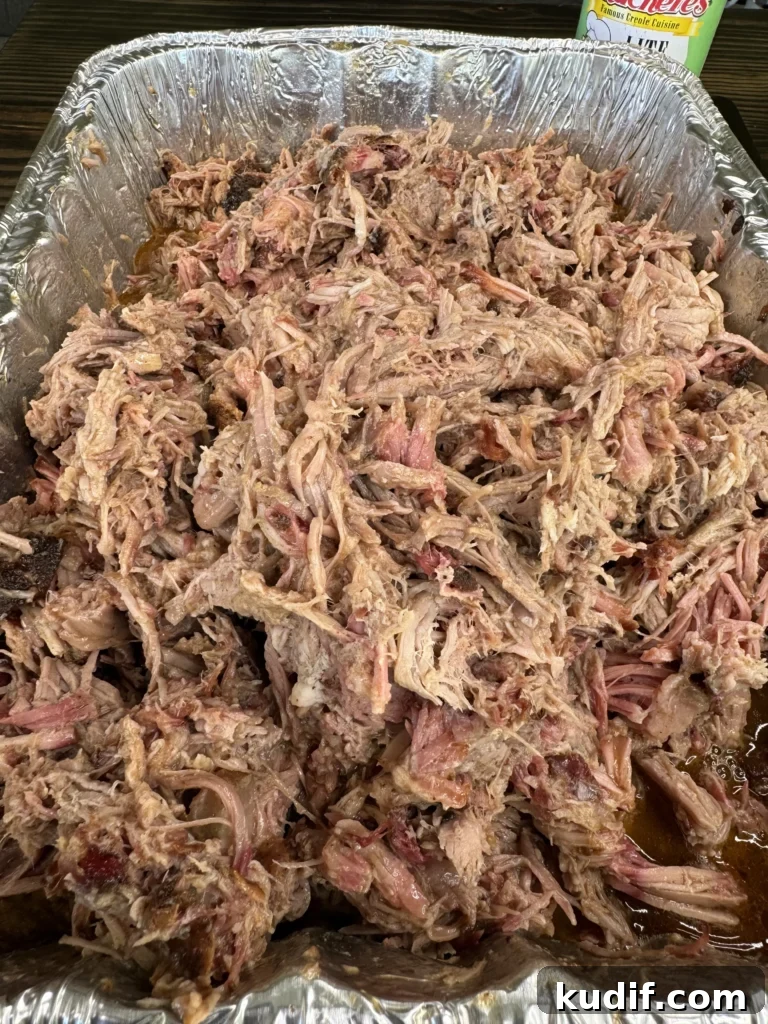 Cajun Pulled Pork Tacos with Tangy Slaw and Lime 3 pulled pork in a pan