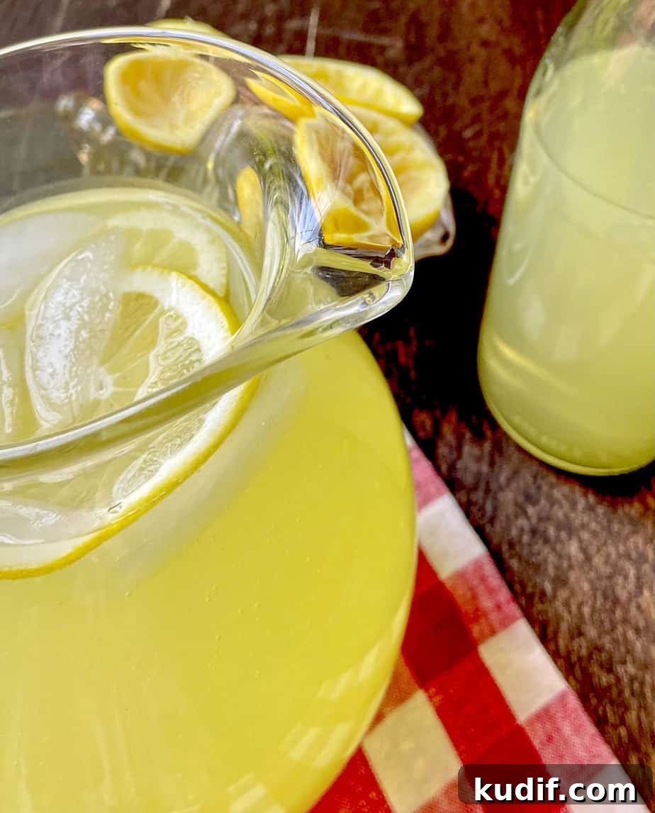 Homemade lemonade in pitcher with ice.