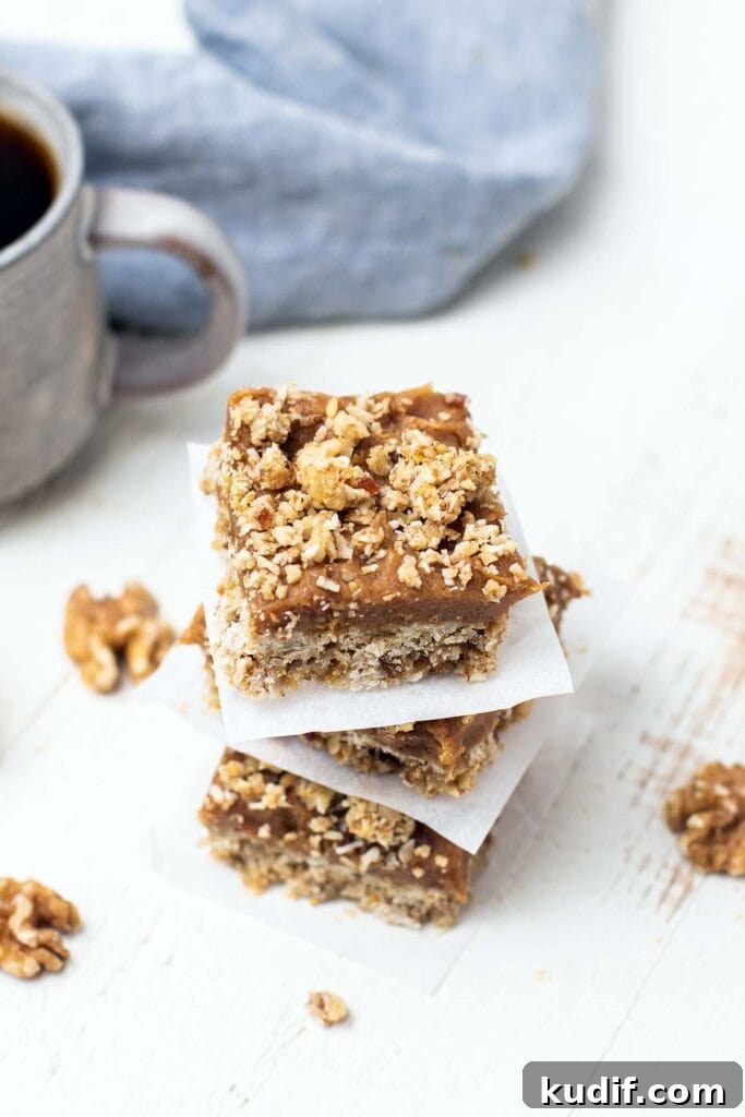 Sugar-Free Gluten-Free Date Bars: Soft Chewy Snack Recipe 2 A stack of 3 date bars next to a cup of coffee.