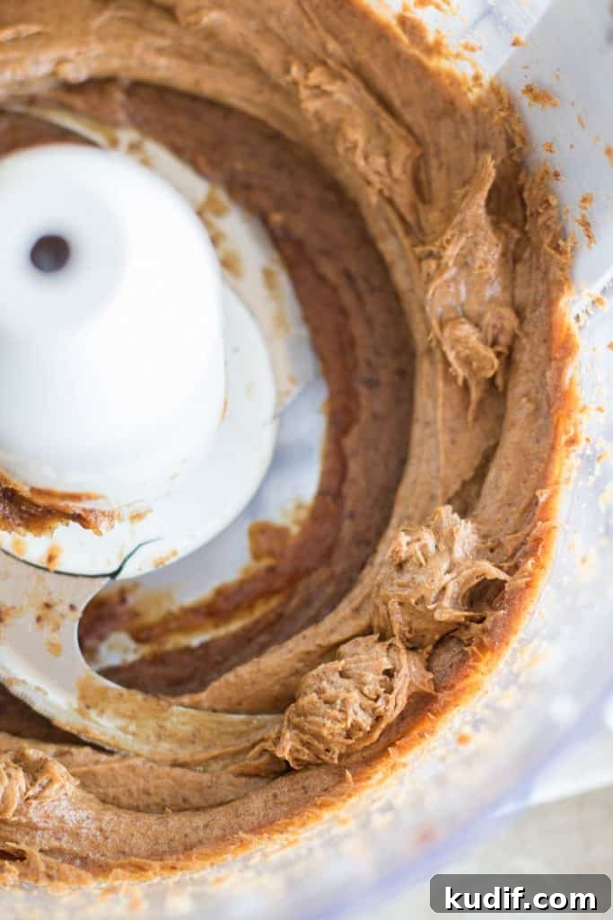 Sugar-Free Gluten-Free Date Bars: Soft Chewy Snack Recipe 3 A food processor bowl showing the texture of the processed dates.