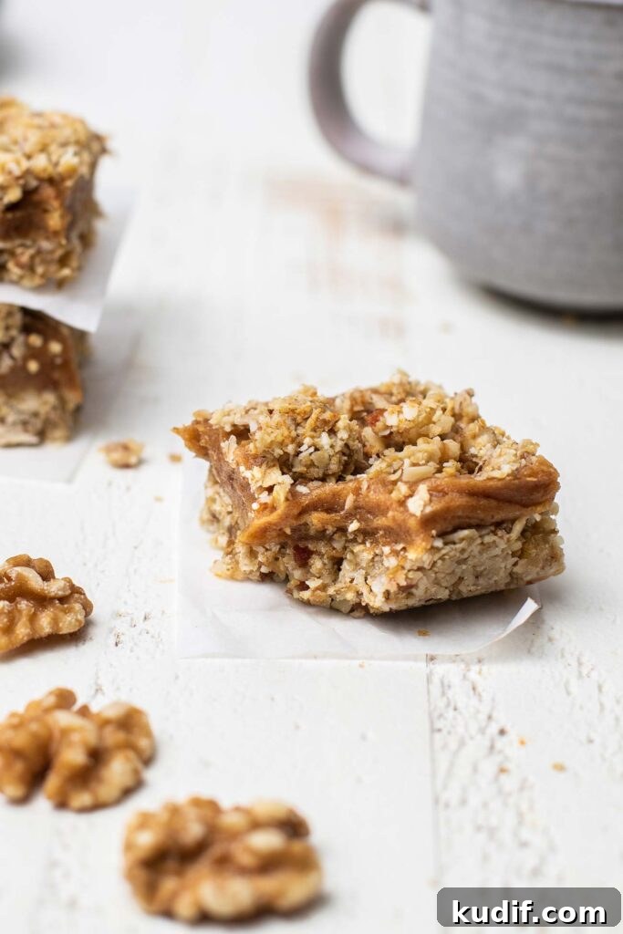 Sugar-Free Gluten-Free Date Bars: Soft Chewy Snack Recipe 10 A date bar with a bite taken out showing the chewy texture.