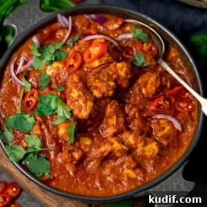 Authentic Chicken Madras Curry Recipe for Bold Flavor 15 chicken madras in a serving bowl topped with chilles and coriander