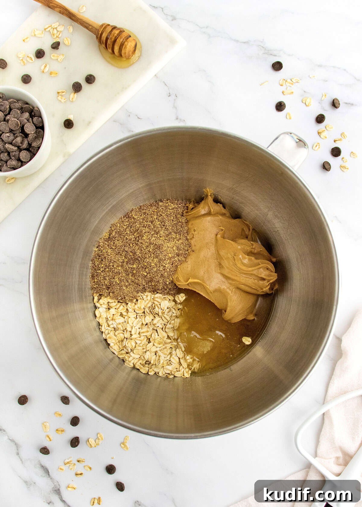No-Bake Protein Energy Bites for Quick Snacks 5 Ingredients to make no-bake energy bites in a stainless steel mixing bowl.