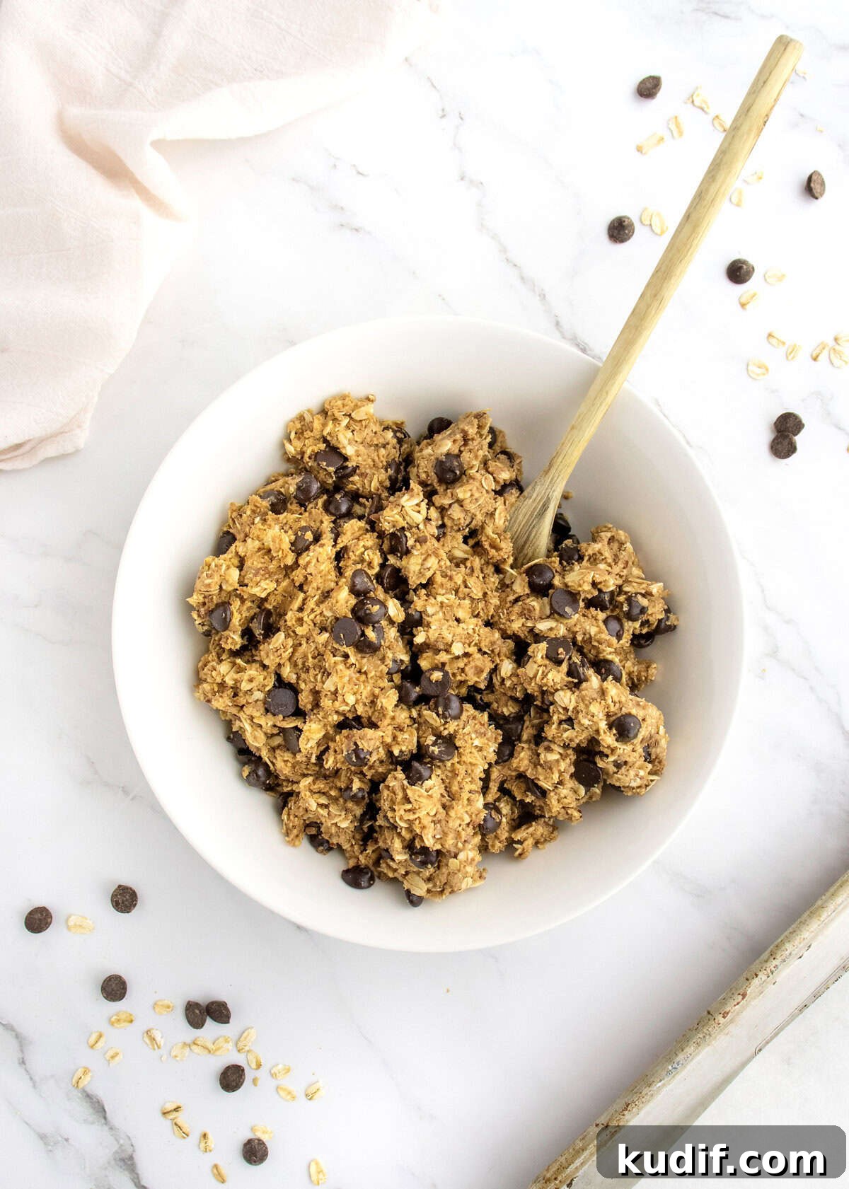 No-Bake Protein Energy Bites for Quick Snacks 6 Chocolate chips stirred into energy bites dough.