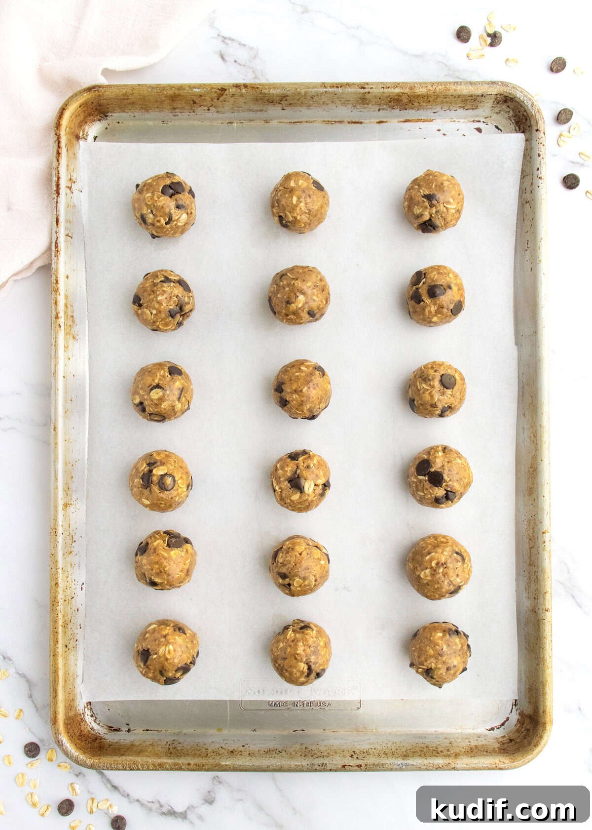 No-Bake Protein Energy Bites for Quick Snacks 7 21 energy bites on a parchment lined aluminum baking sheet.