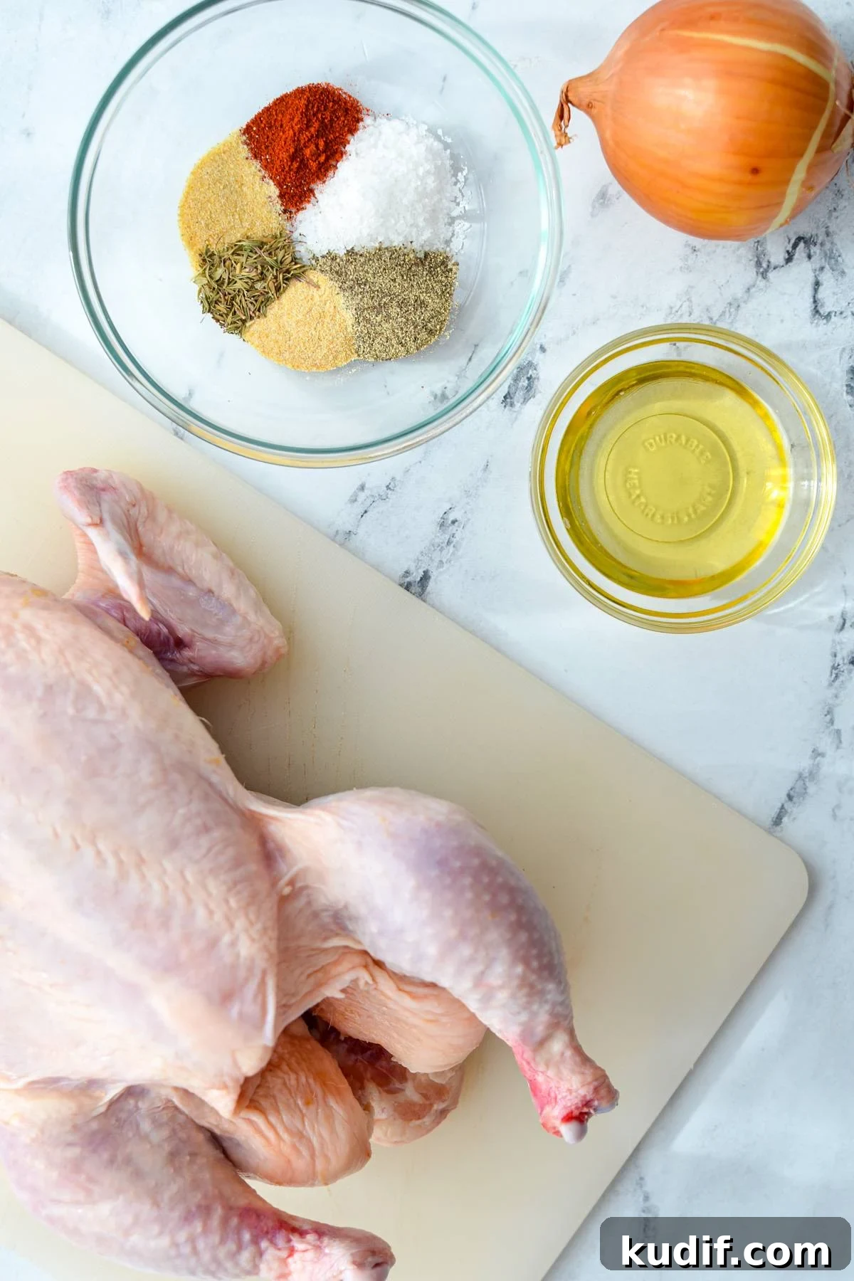 Rotisserie-Style Whole Chicken in the Air Fryer 3 The ingredients needed to make an air fryer whole chicken: chicken, oil, onion, and seasonings.