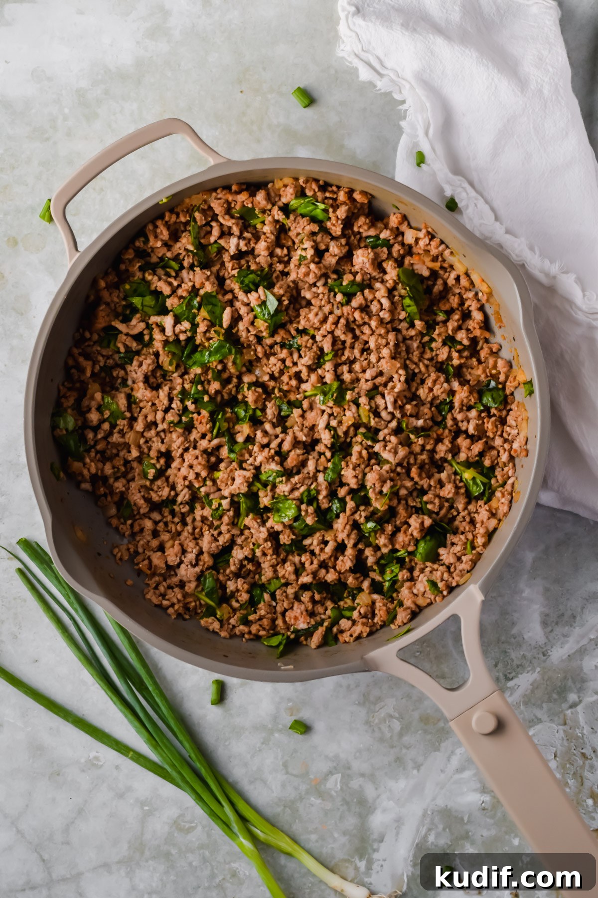 filling for healthy ground turkey enchiladas in tan skillet.