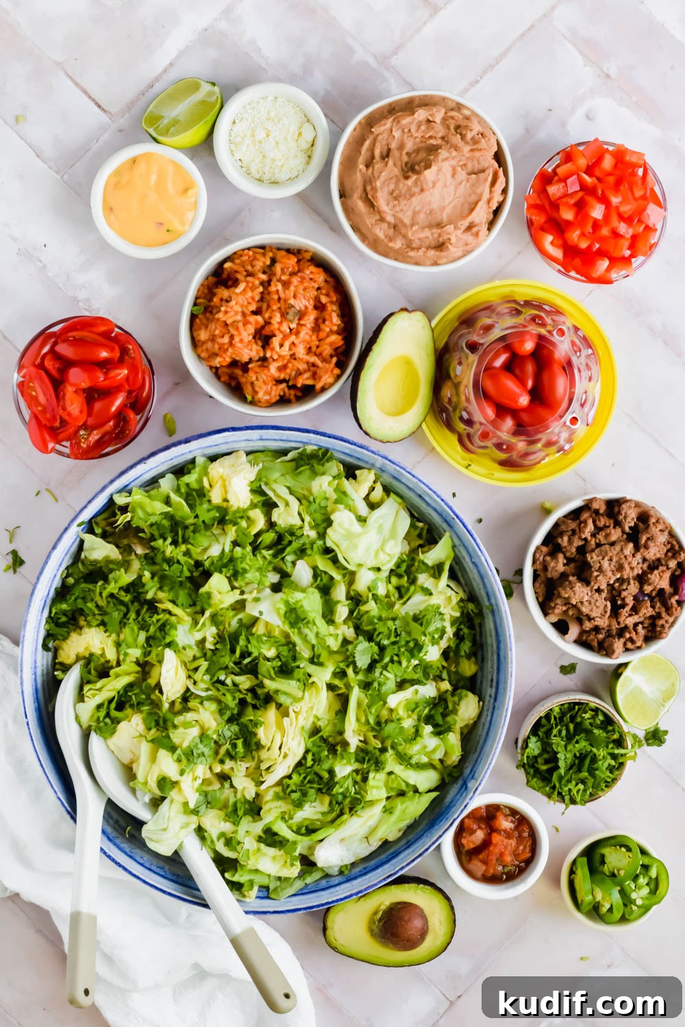 ingredients for Mexican 7 layer salad in individual bowls on white background.