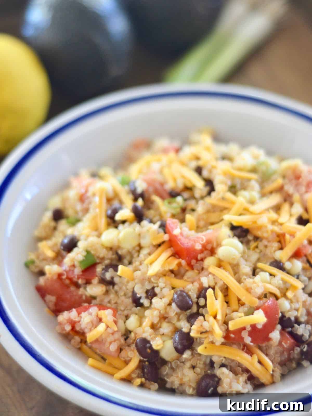 Mexican-Style Quinoa Salad with Corn, Black Beans & Lime Dressing 2 Mexican Quinoa Salad recipe with corn and black beans in a white bowl.