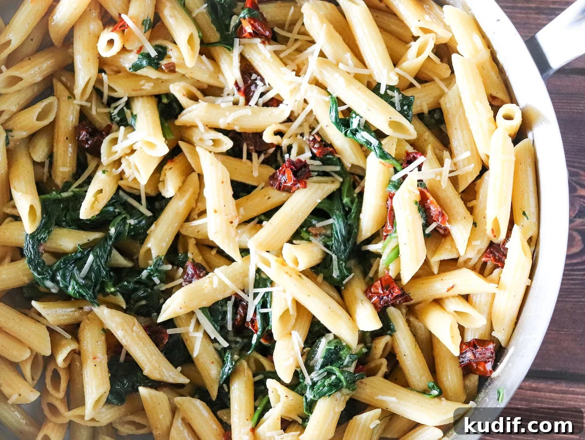 Protein Pasta with Sautéed Spinach and Sun-Dried Tomatoes 5 protein pasta topped with parmesan cheese
