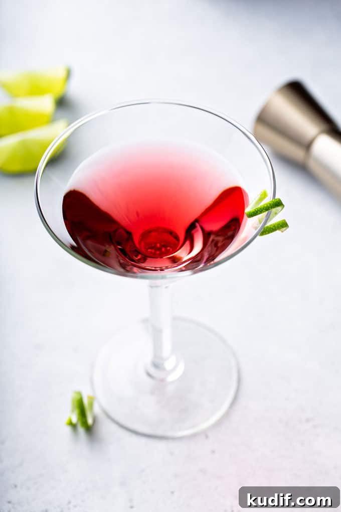 Classic Cosmopolitan Cocktail Recipe: How to Mix the Perfect Cosmo 3 Top view of a cosmopolitan martini with a lime twist