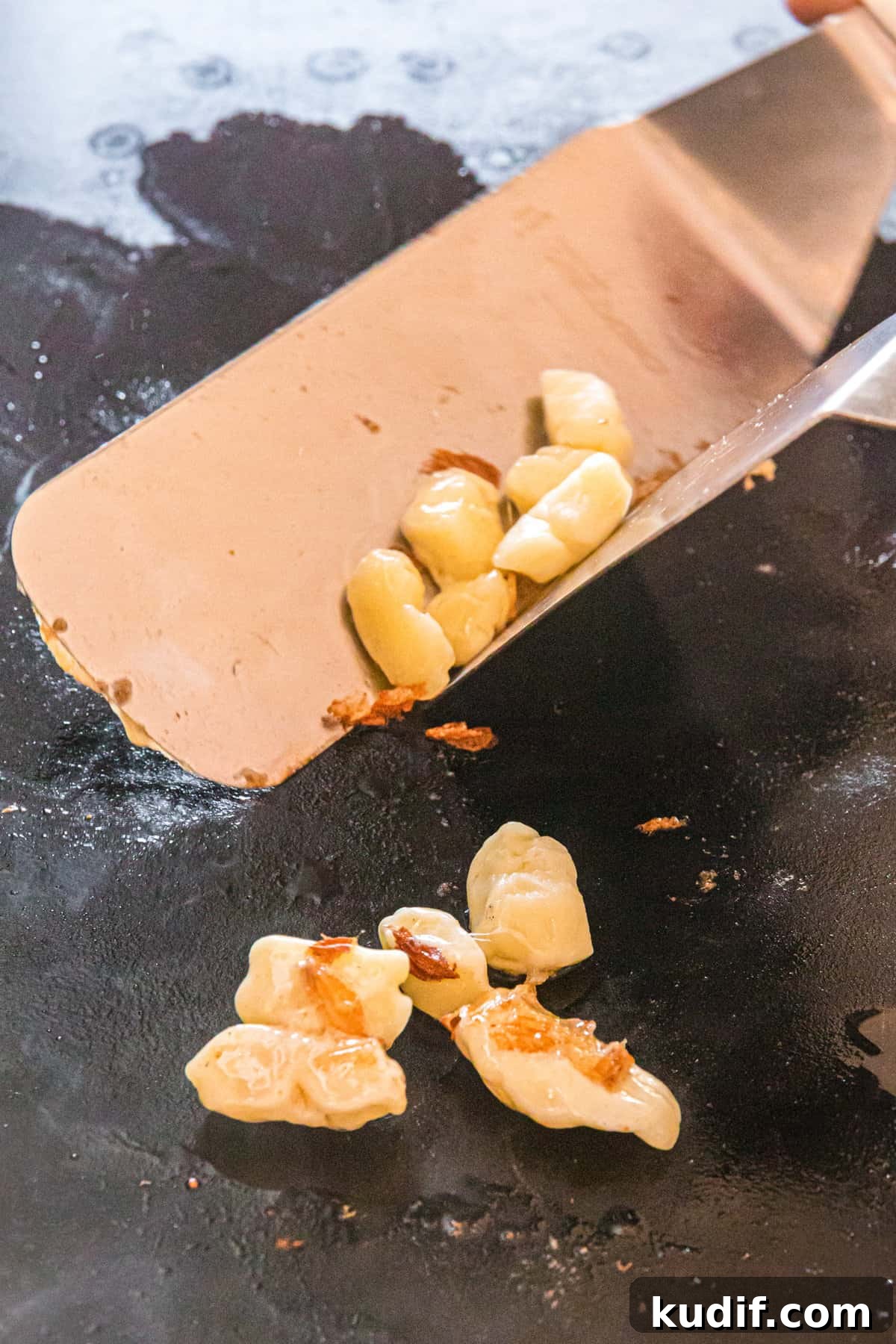 Crispy Blackstone Cheese Curds Recipe for Crowd-Pleasing Snack 4 Blackstone Cheese Curds on griddle with large spatula