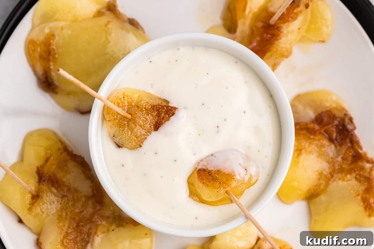 Crispy Blackstone Cheese Curds Recipe for Crowd-Pleasing Snack 7 Blackstone Cheese Curds with toothpick skewer in dipping sauce