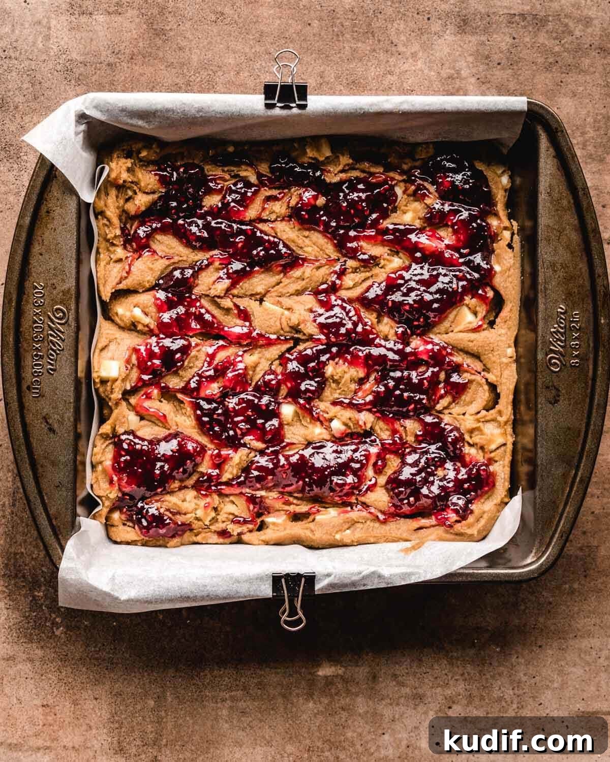 White Chocolate Raspberry Blondies with Tangy Fruit Swirls 11 Raspberry sauce swirled over white chocolate blondie batter.