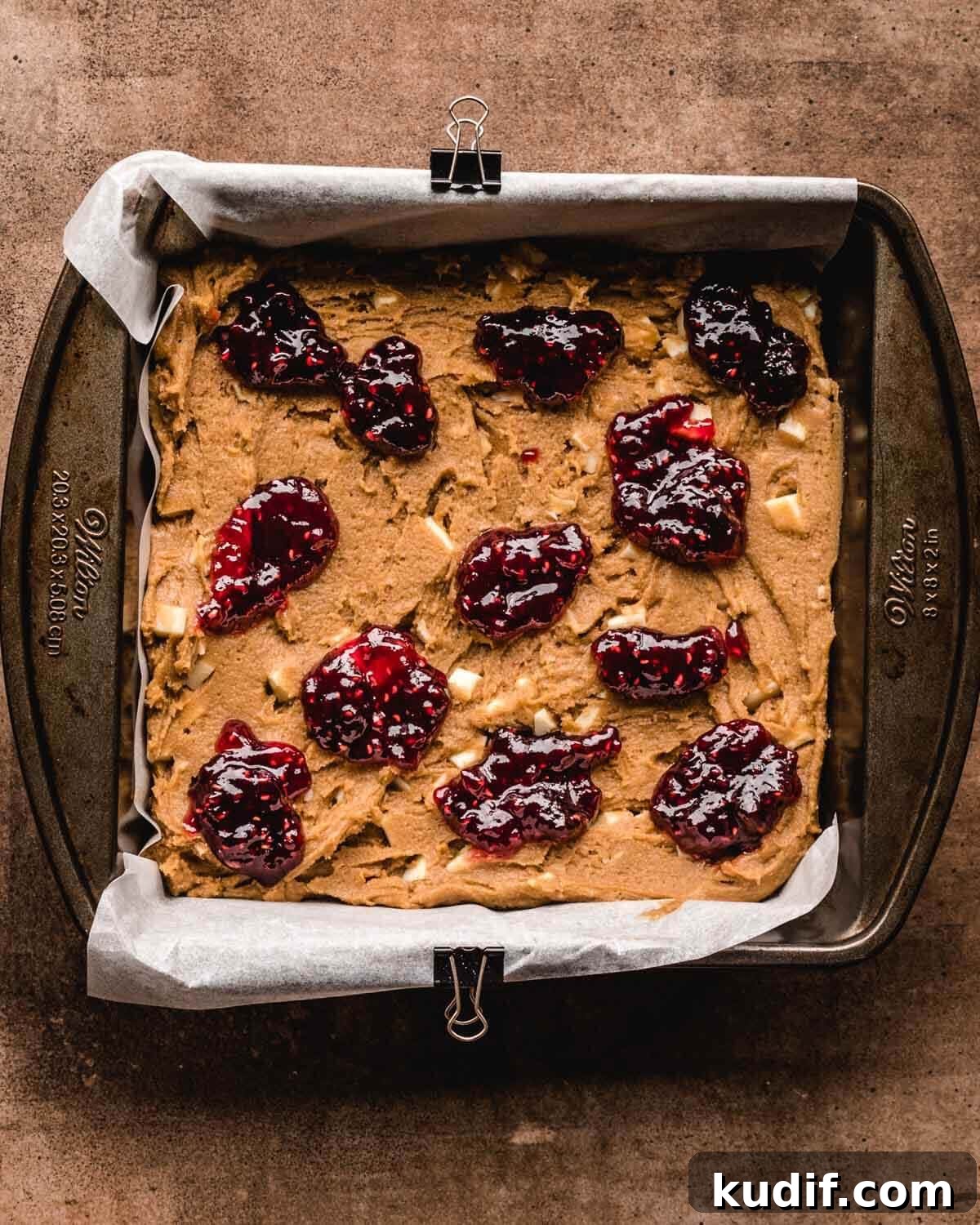 White Chocolate Raspberry Blondies with Tangy Fruit Swirls 10 Dollops of raspberry sauce added to the top of blondie batter before being swirled.