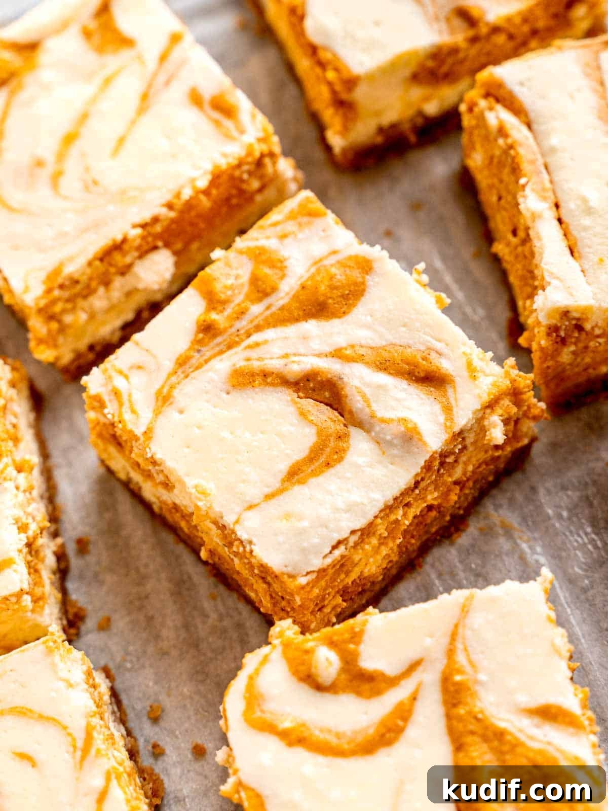 Pumpkin Cheesecake Bars Recipe for Fall Dessert Lovers 11 Cooled pumpkin cheesecake bars cut into squares.