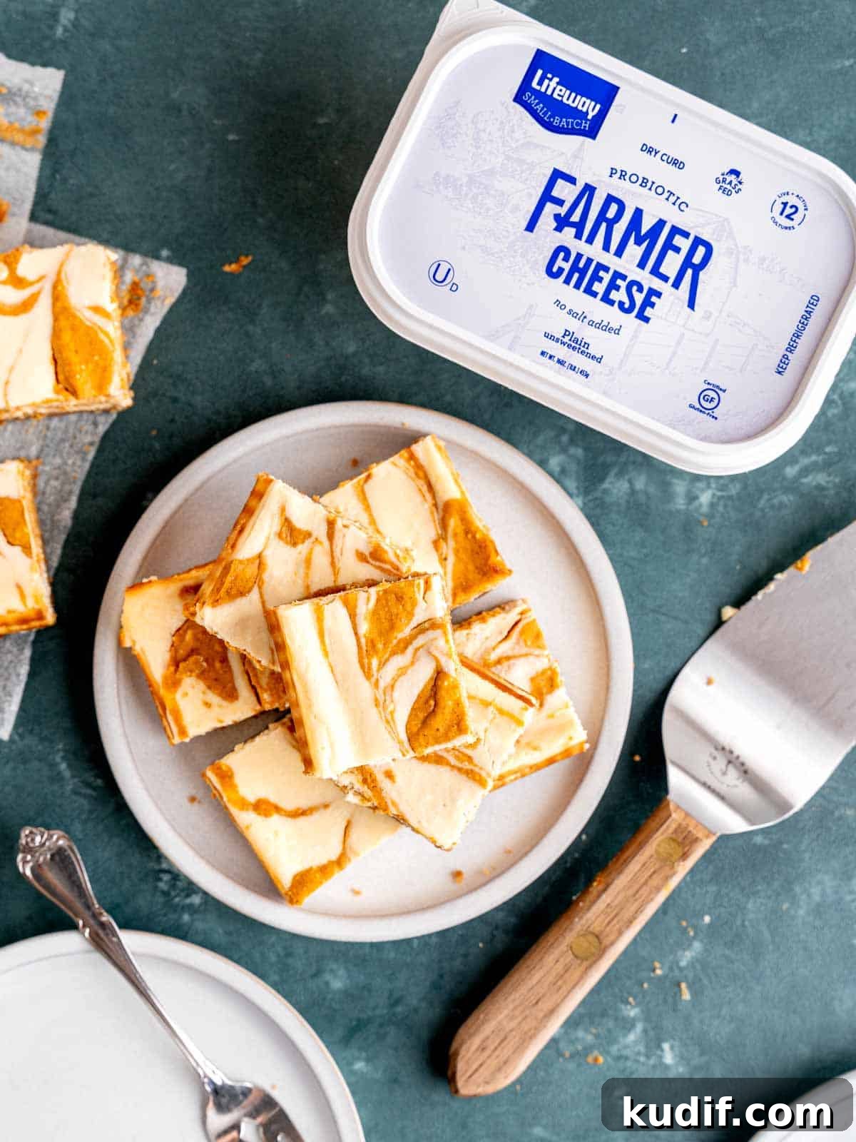 Pumpkin Cheesecake Bars Recipe for Fall Dessert Lovers 12 A plate of pumpkin cheesecake bars next to Lifeway Farmer Cheese.